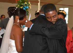 As he prepares to marry Dorothie, Pere Wilky Avril embraces her father during the wedding at St. Trinity Episcopal Cathedral, Port-au-Prince, Haiti, on May 1, 2014.