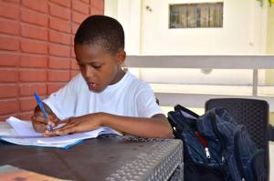 Carlins, 9, hard at it. He spends a lot of time on homework, and his report card proves it!